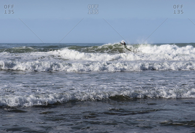 Man surfing fierce waves - Offset