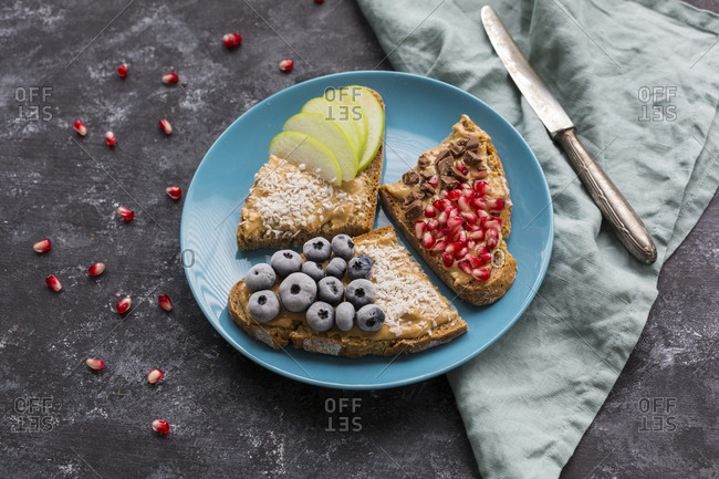 Bread slices with various toppings on plate