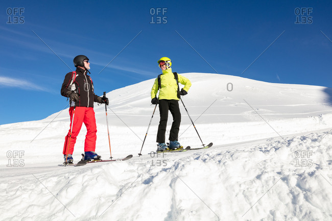 Skier couple skiing on snowy landscape during winter