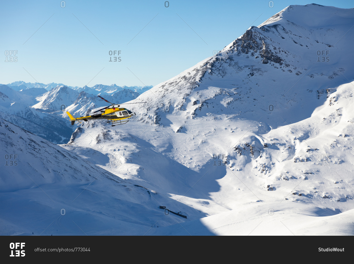 Rescue helicopter flying in a snowy landscape