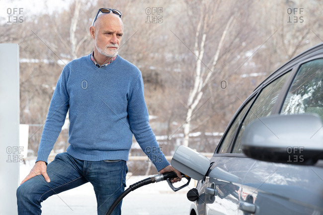 Man refueling his car at a gas station