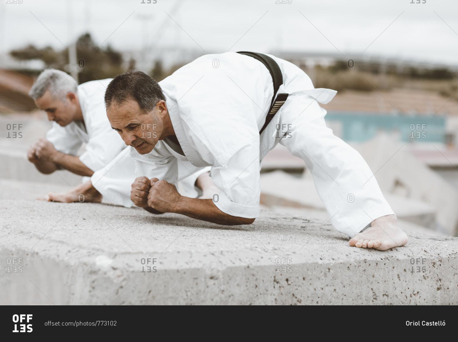 Karate fighters practicing martial art stretches