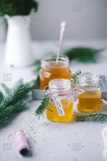 Jars filled with freshly made ghee garnished with pine needles
