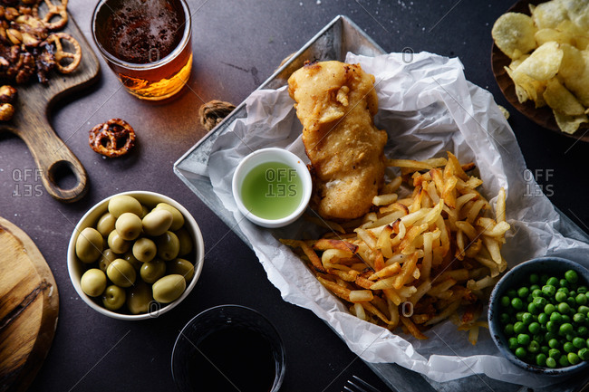 Overhead image of beer party with various snacks and fish-and-chips