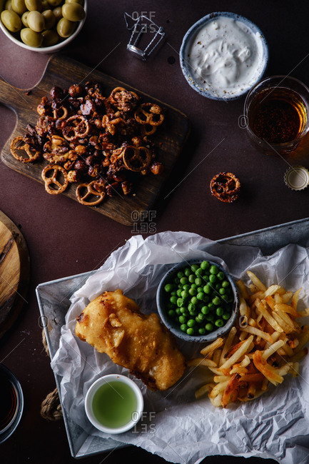 Overhead image of beer party with various snacks and fish-and-chips