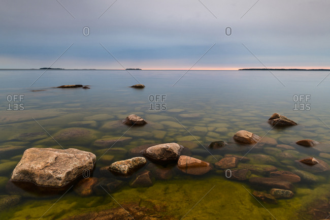 Rock formations by sea at dawn