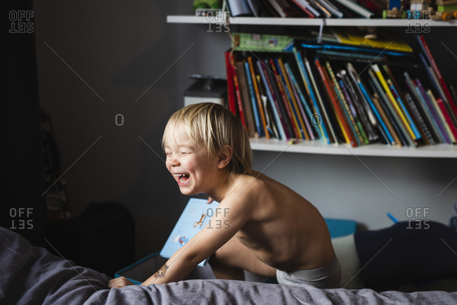 Boy playing on bed