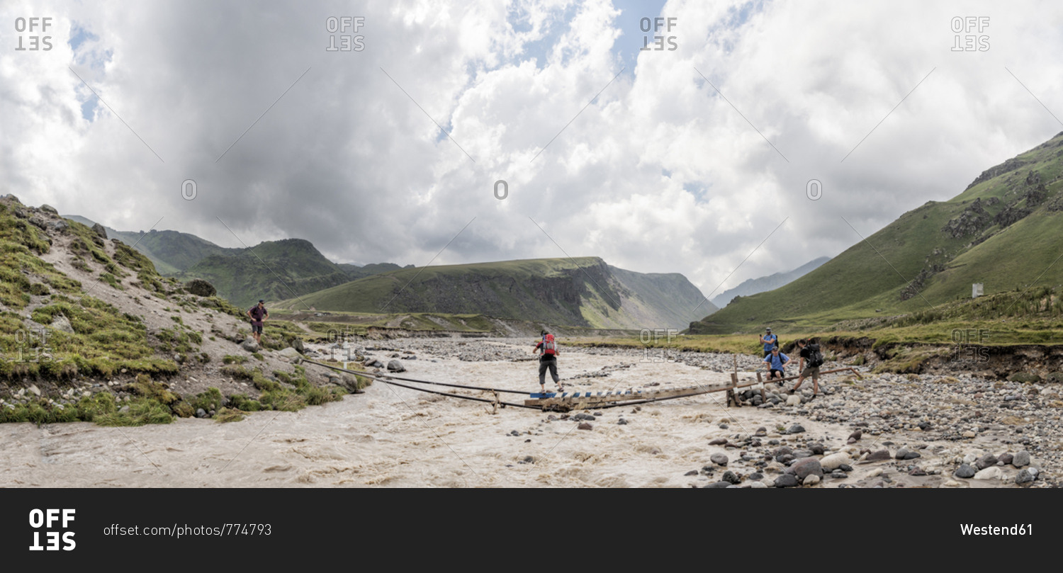 Russia- Caucasus- Mountaineers crossing river in Upper Baksan Valley