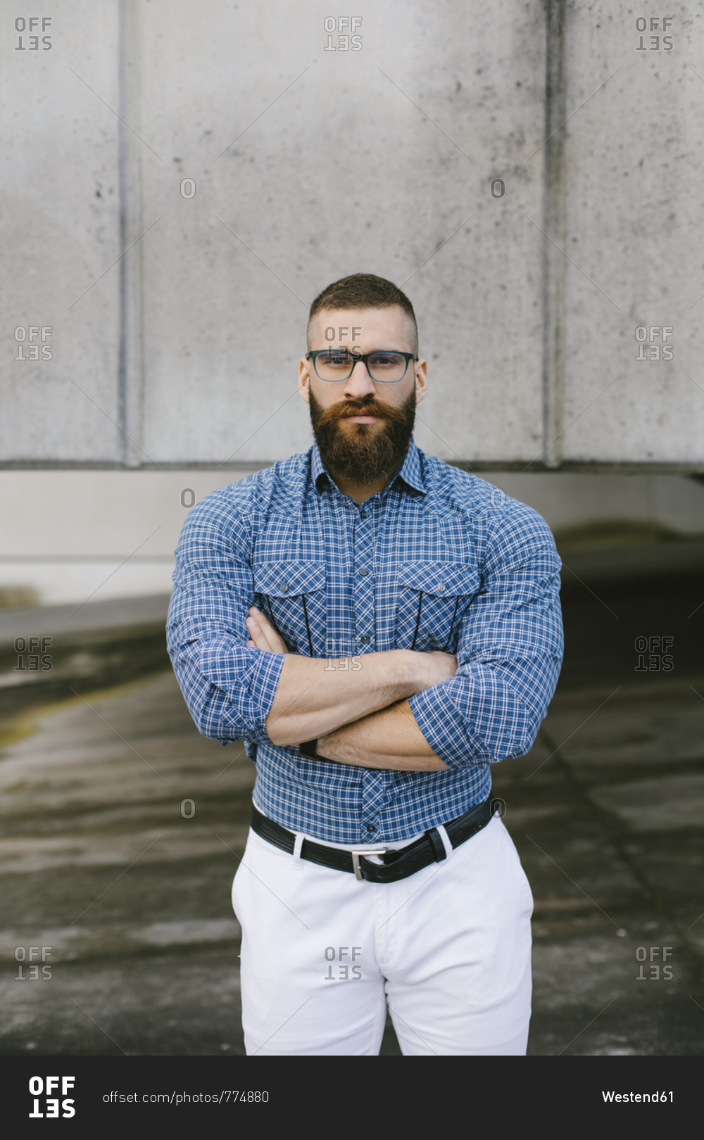 Portrait of bearded hipster businessman wearing glasses and plaid