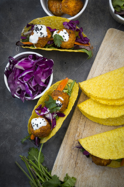 Sweet potato falafel in taco shells- with red cabbage- salad- carrot- yogurt sauce and black sesame