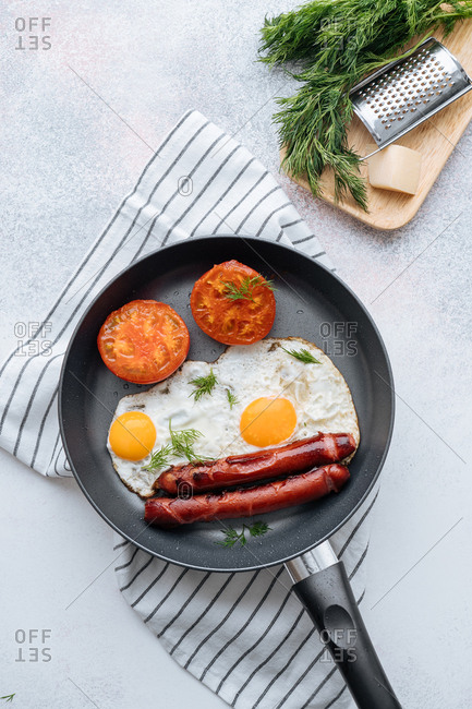 Overhead view of frying pan and cooked breakfast