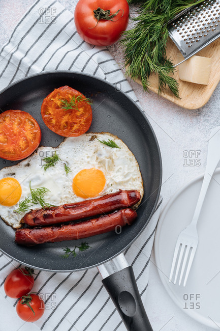 Overhead view of frying pan and cooked breakfast