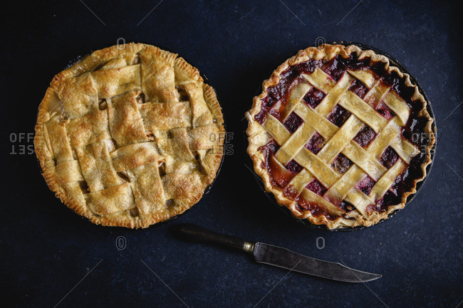 Apple pie and pie with berries on dark background