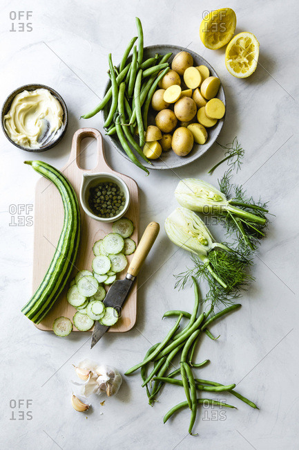 Ingredients for Green goddess potato salad. Potatoes, fennel, lemon, cucumber, green beans.