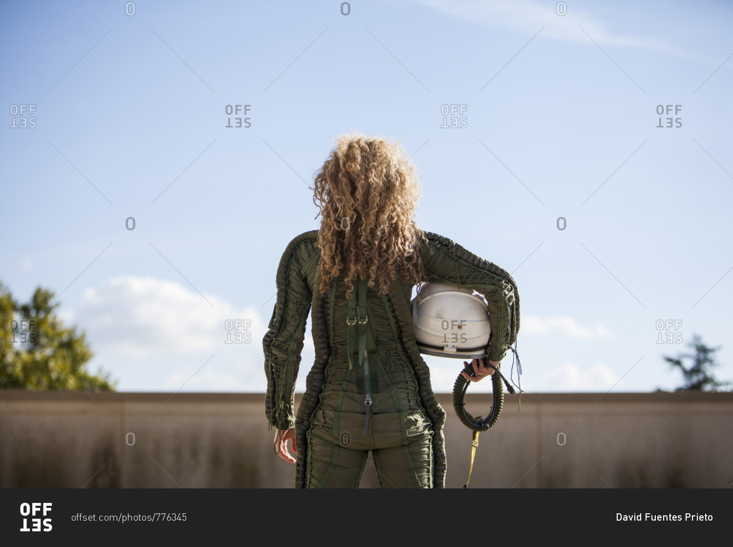 beautiful and young blonde dressed as russian aeronautic pilot, portrait back half-length portrait without a helmet