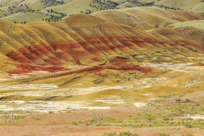 USA, Oregon, Redmond, Bend, Mitchell. Series of low clay hills striped in colorful bands of minerals, ash and clay deposits.