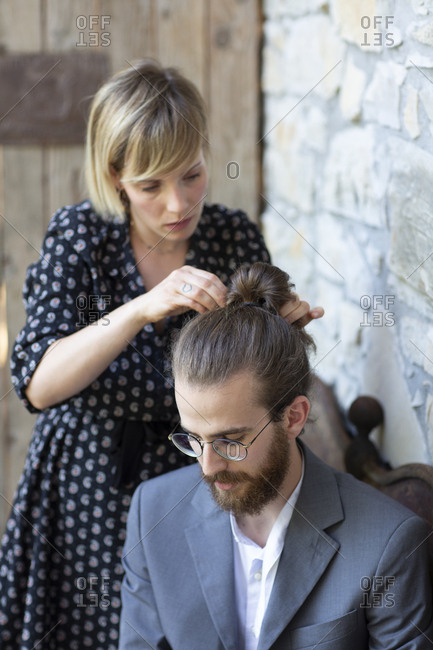 Woman Doing Hair Of Young Man In Grey Suit Stock Photo Offset