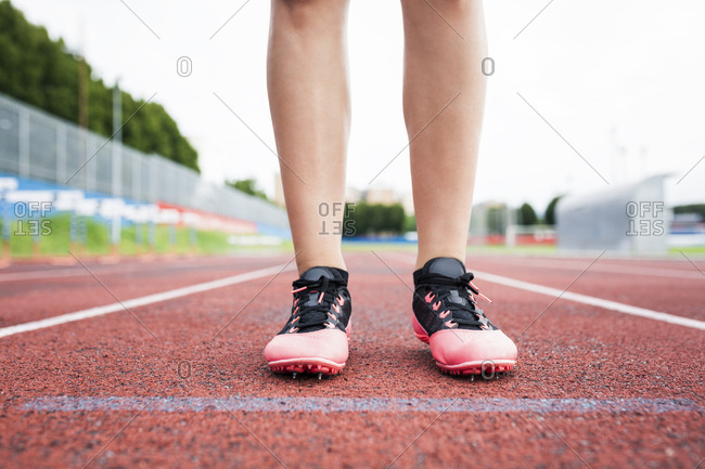Feet of a runner- standing on race track