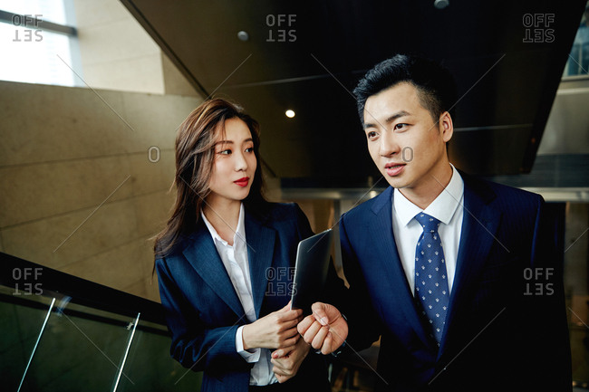 Business people talking in the elevator