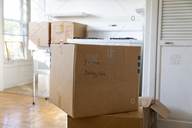 Moving boxes stacked in kitchen