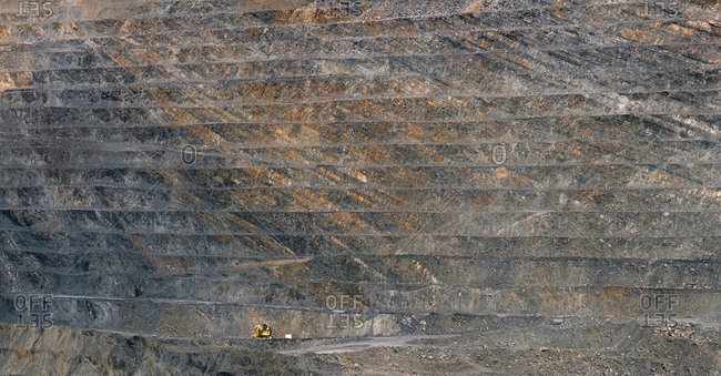 Rough surface of huge open pit of Santa Lucia Mine on sunny day in Leon, Spain