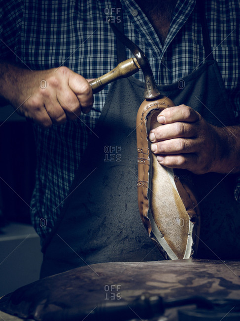 Anonymous man making shoes