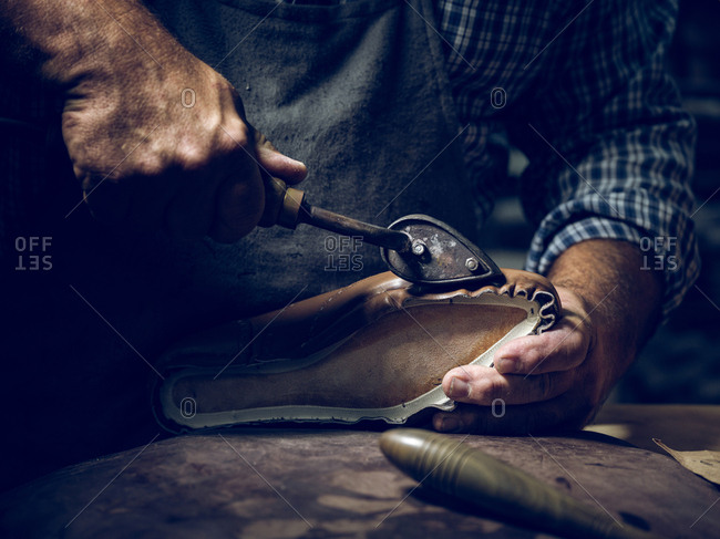 Anonymous man making shoes