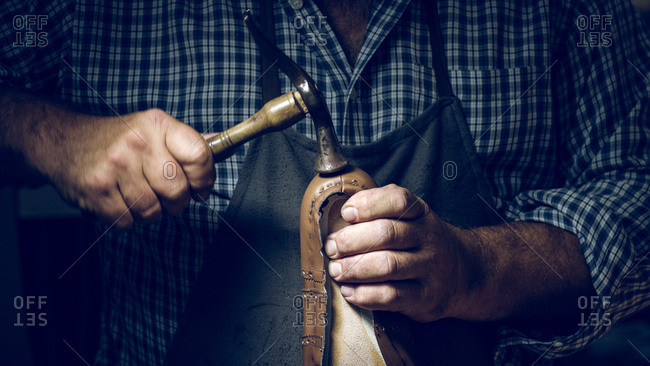Anonymous man making shoes