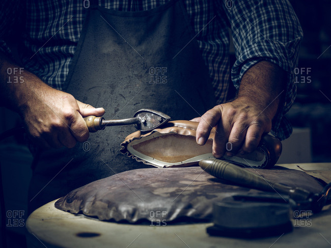 Anonymous man making shoes