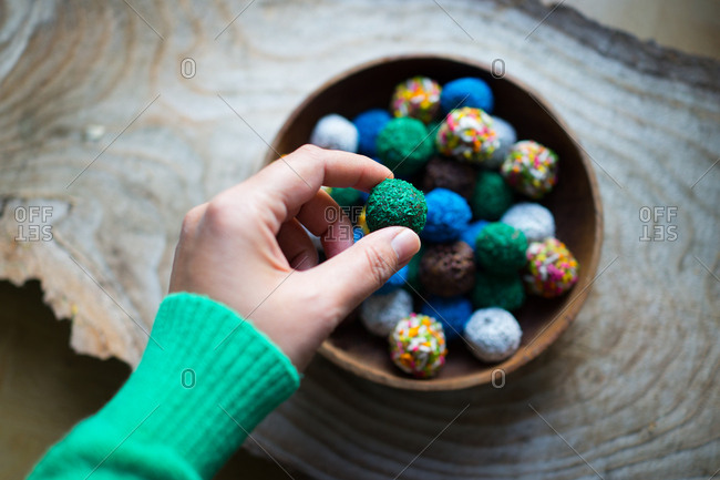 Hand holding round colorful cookie ball