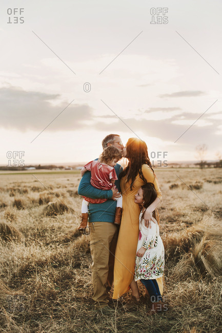 A family of four embracing