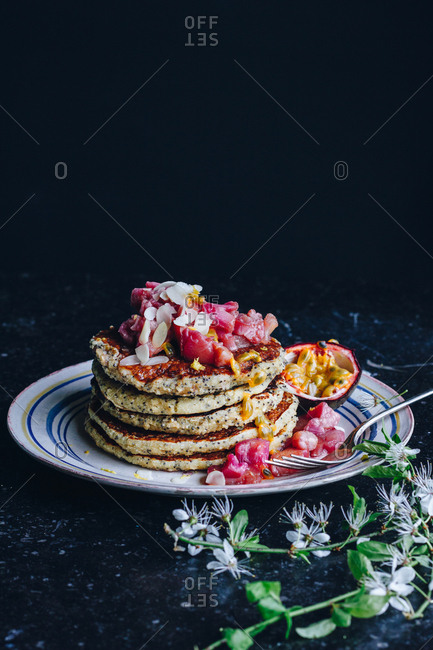 Stack of vegan pancakes topped with rhubarb