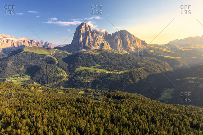 Elevated view of the forest above Gardena Valley with view on Sassolungo Group, South Tyrol, Dolomites, Italy, Europe