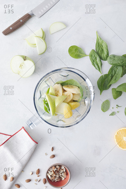 Smoothie and ingredients on counter in a blender