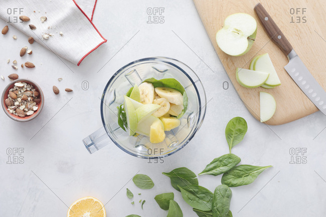 Fruit smoothie and ingredients in a blender