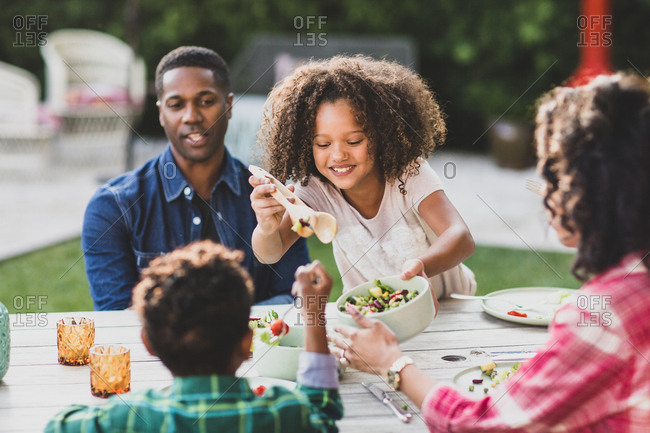 African American family having a family meal outdoors