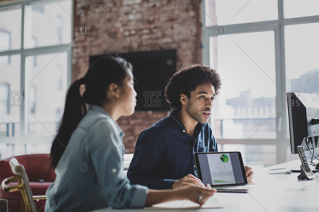African American businessman leading a meeting