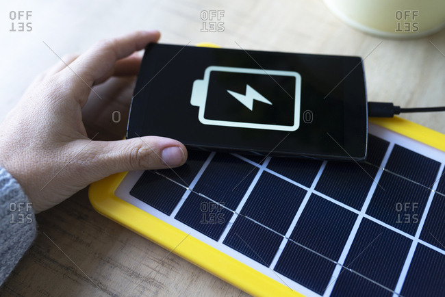 Renewable energy technology- solar panel charging a mobile phone battery