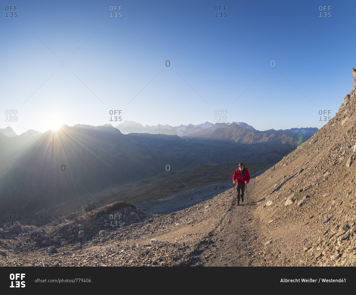 Border region Italy Switzerland- senior man hiking in mountain landscape at Piz Umbrail