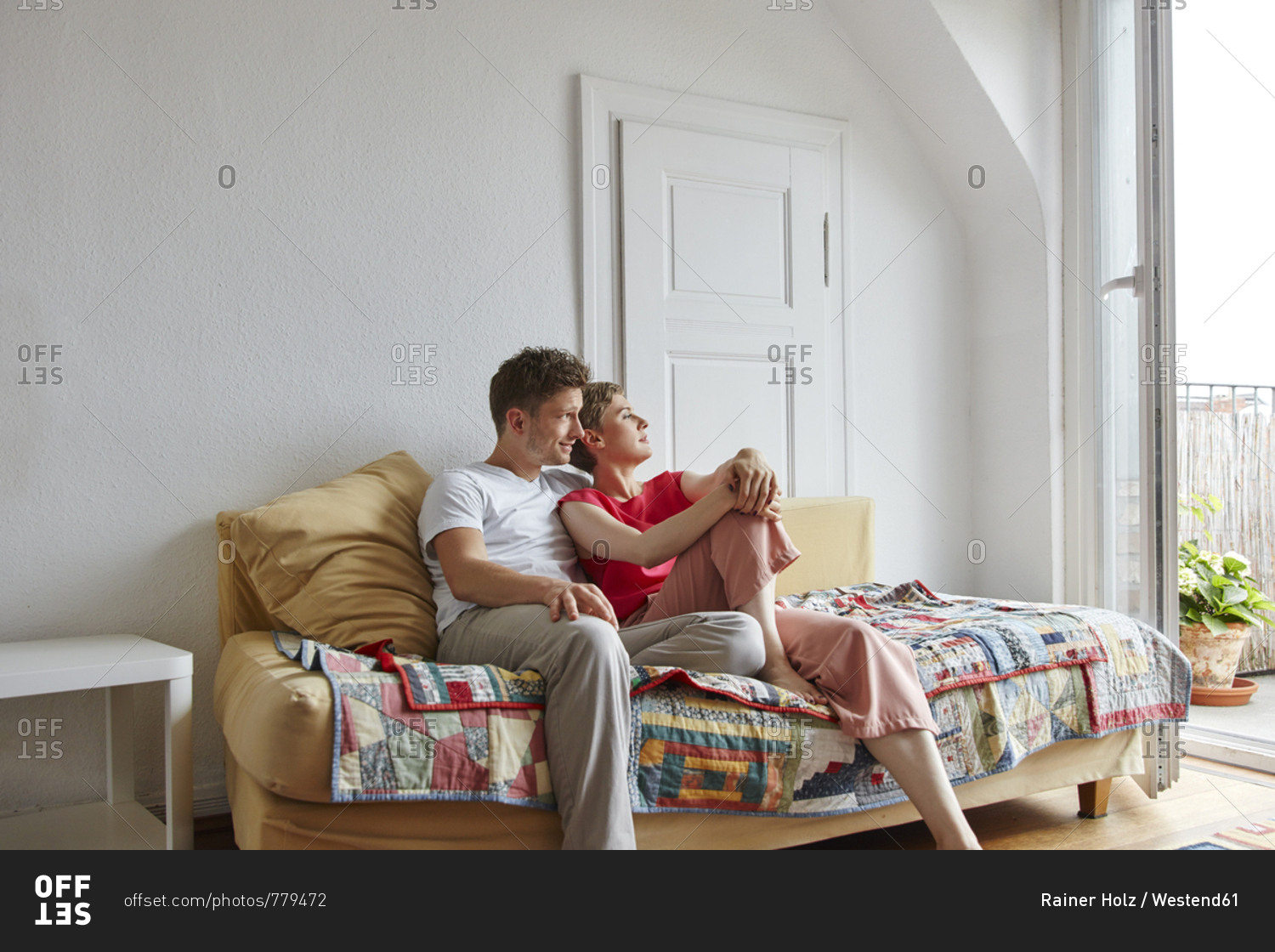 Relaxed couple sitting on couch at home