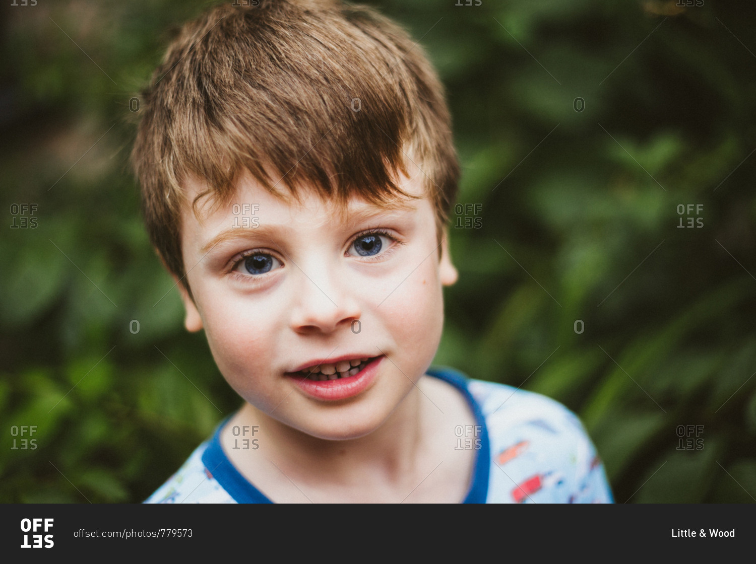 Portrait of a smiling boy with light brown hair and blue eyes stock photo -  OFFSET