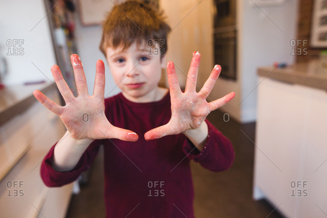 Boy showing his messy hands