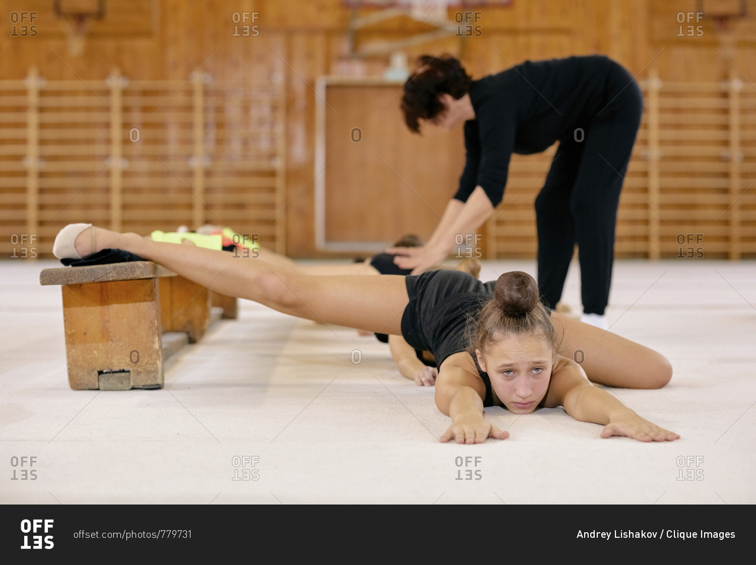 Young Gymnast Girl Warming Up Before Training She Stretching Her Leg