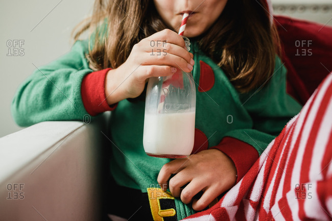 Little girl drinking milk in her chrismtas pajamas