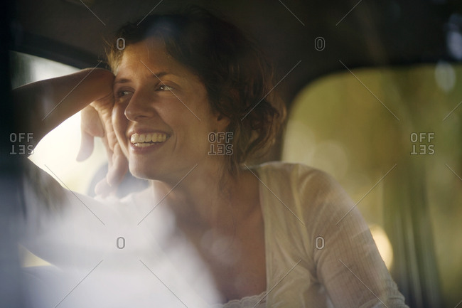 View of a young woman sitting in a car.