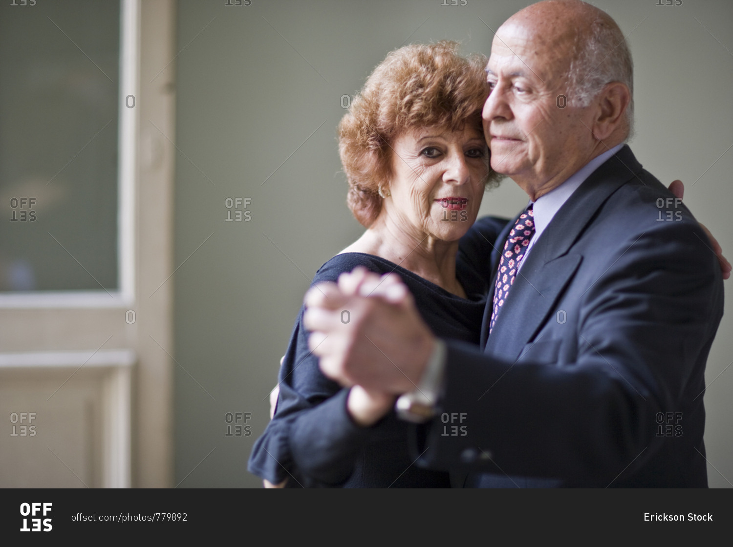 Portrait of a mature woman dancing with her senior husband.