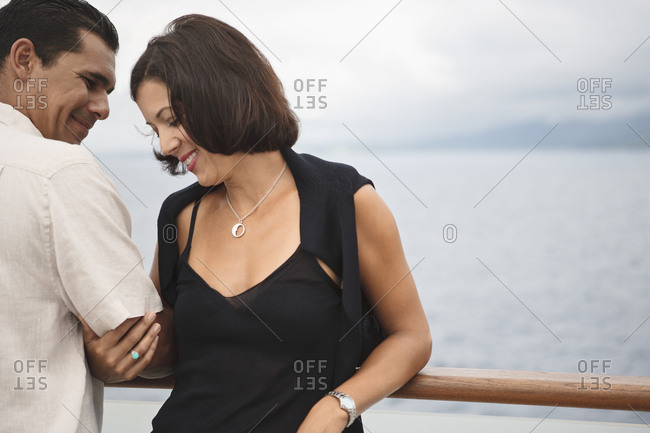 Couple relaxing on boat deck aboard a cruise ship.