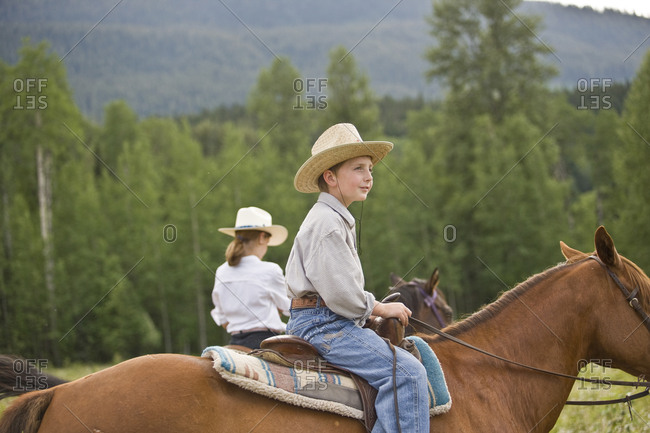 Boy and girl horseriding
