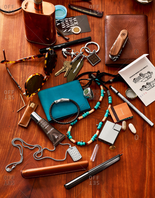 June 9, 2016: Overhead view of a cluttered desk with cologne, jewelry, a wallet, and other items