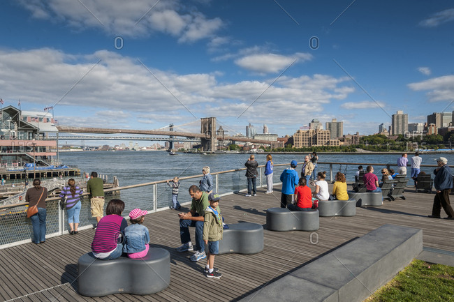 September 22, 2013: USA, New York, New York City, Manhattan . Pier 15, a two-level, reconstructed waterfront pier opened to the public in late Fall 2011. The Pier offers expansive views of the East River and Manhattan and Brooklyn skylines. Pier 15 features an elevated lawn area, chaise lounge seating, and two separate look-outs.